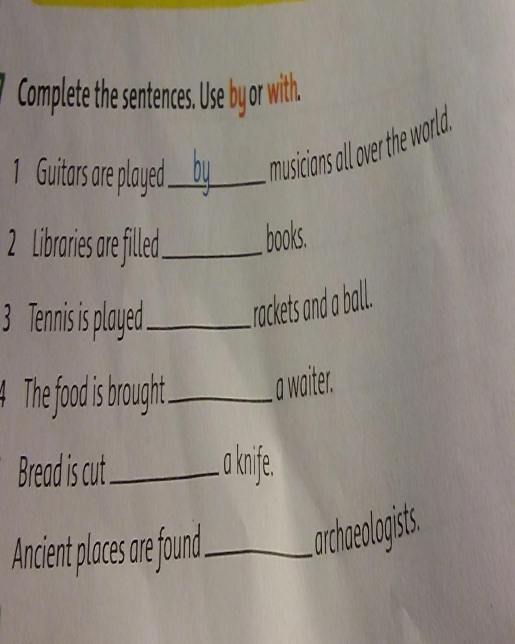 7 Complete the sentences. Use by or with. 11 Guitars ar played by